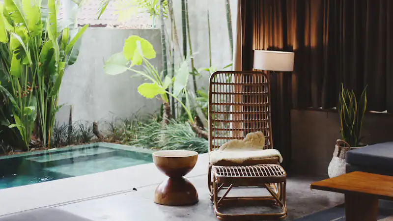 A quiet courtyard with a plunge pool, lounge chair and tropical plants